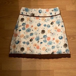 Cream color with peach and blue floral skirt